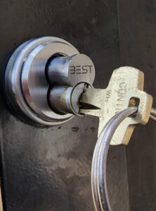 A lock with a key attached to it, requiring the expertise of a Locksmith Services.