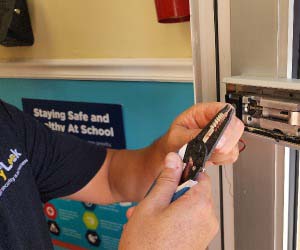 A man working on a door lock.