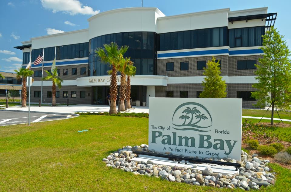 The palm bay medical center sign is in front of a building.
