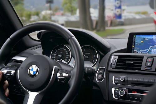 The dashboard of a bmw car with a gps system.