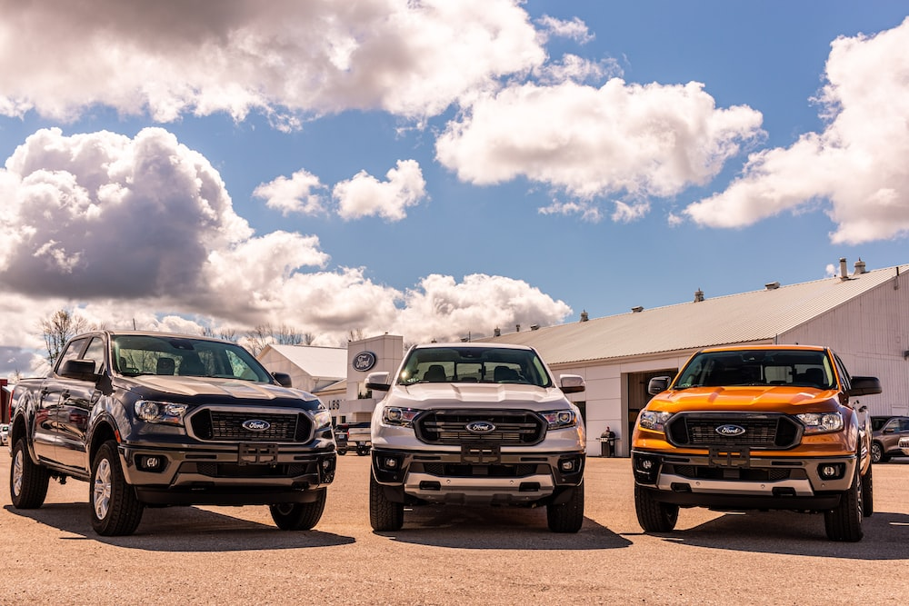 Four 2019 ford rangers parked in front of a building.