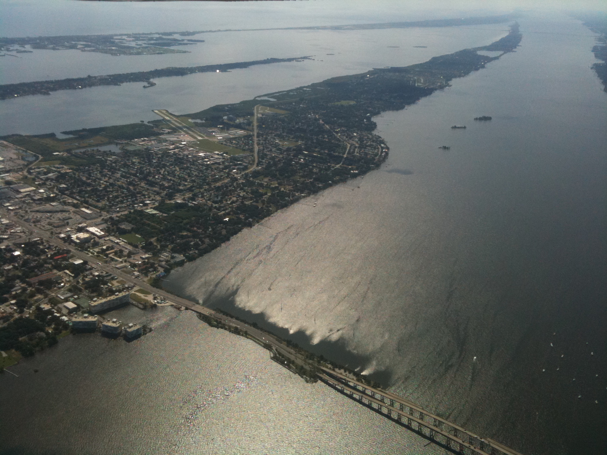 An aerial view of a body of water and a bridge.