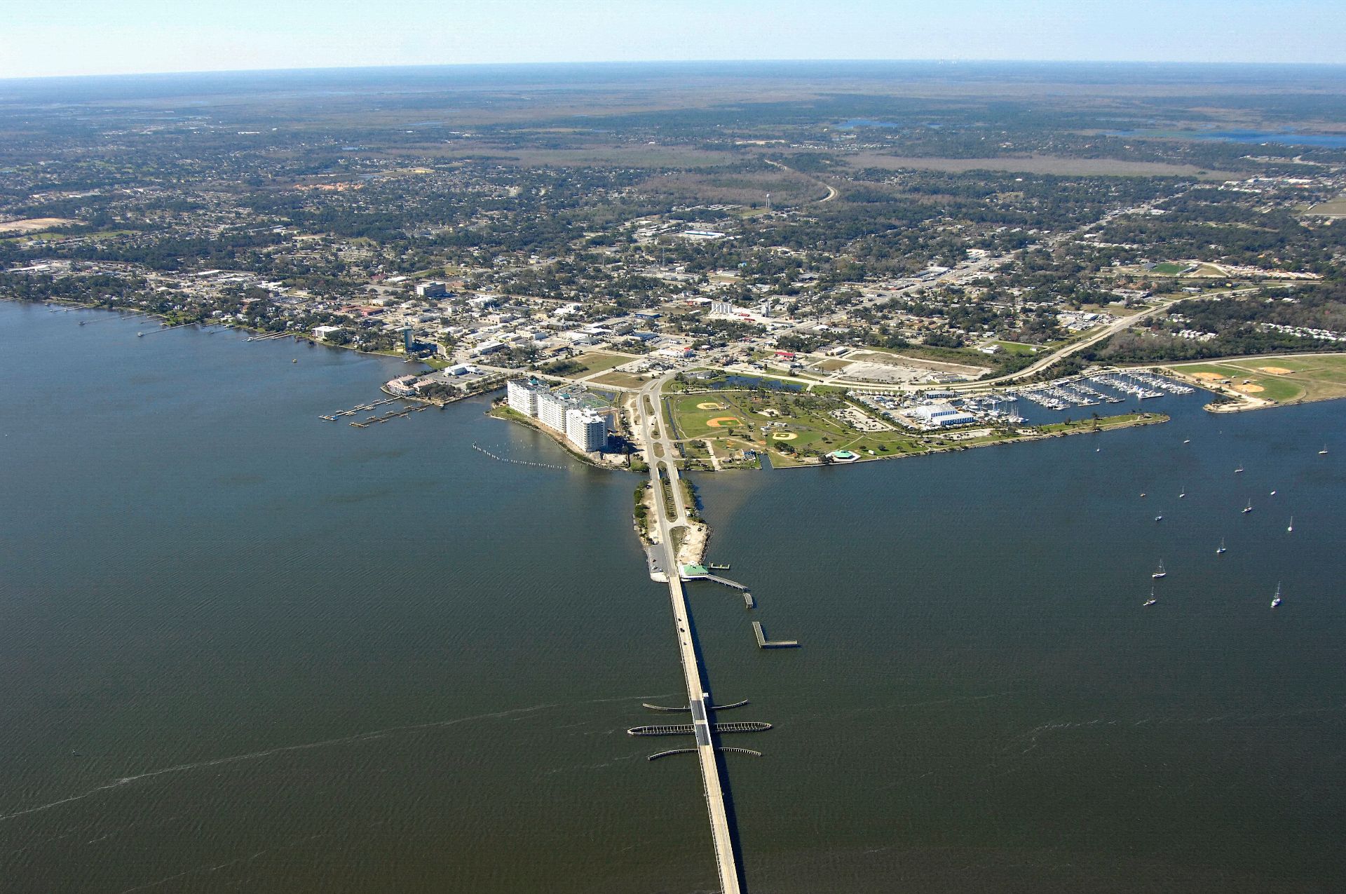 An aerial view of a bridge over a body of water.