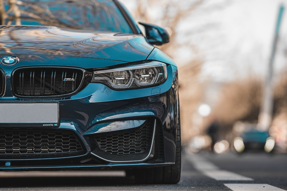 The front end of a blue bmw m4.
