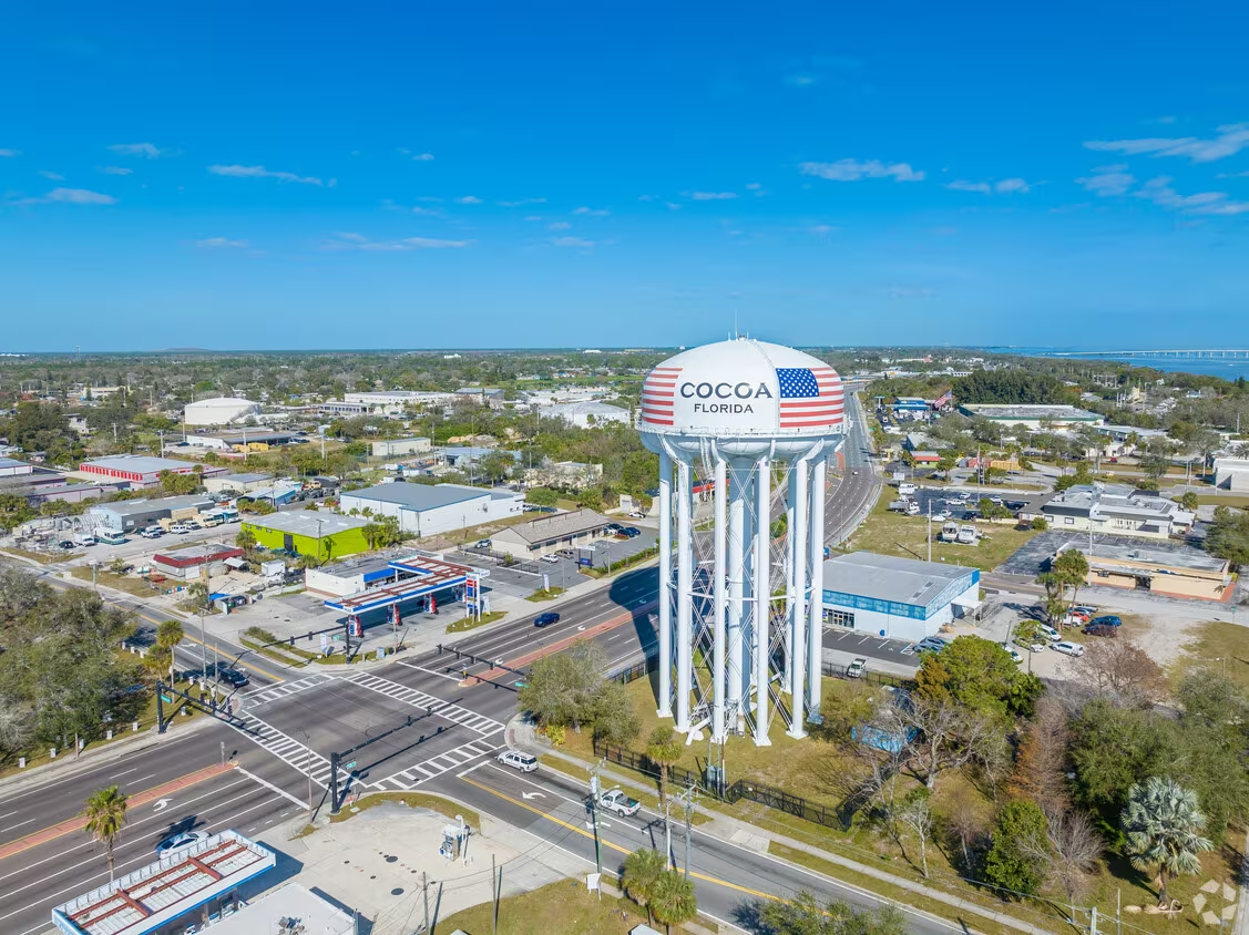 An aerial view of a water tower in a town.