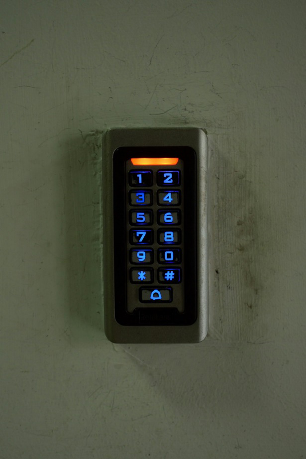 An electronic keypad on a wall.