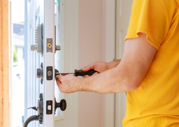 worker installing or repairing new lock handyman repair the door lock